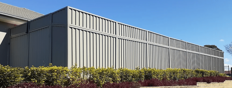 a fence with bushes and bushes